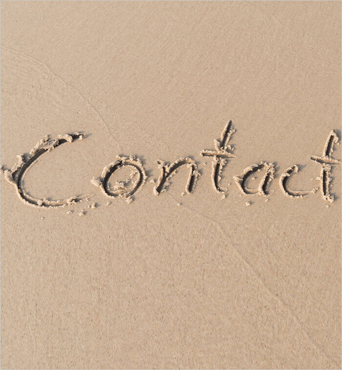 contact word written on sand at the beach