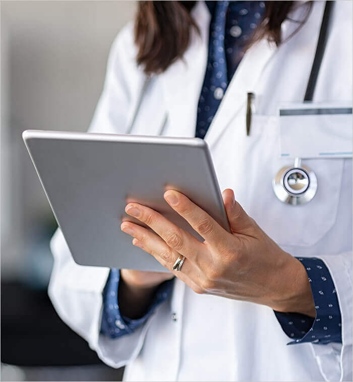 female doctor holding tablet for Telehealth appointment