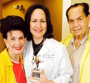 Dr. Irma Lopez next to older man and woman